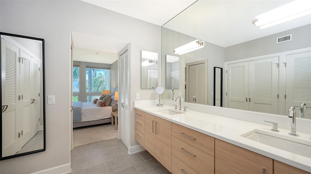 bathroom featuring tile patterned flooring and vanity