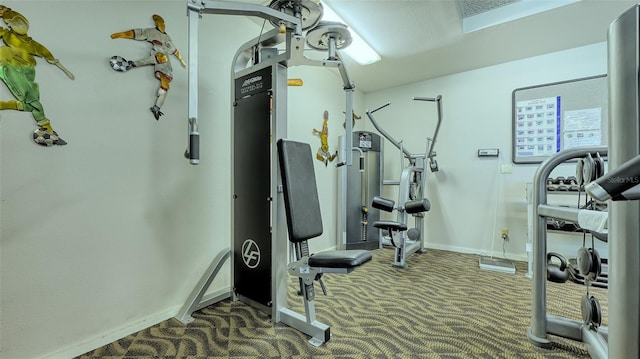 workout area with a textured ceiling and dark colored carpet