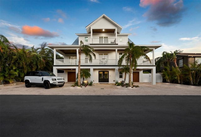 beach home featuring french doors, a balcony, and a garage