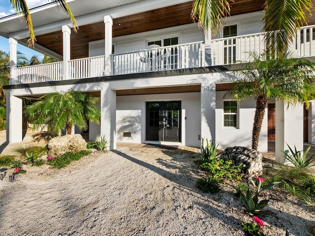 back of house featuring french doors and a balcony