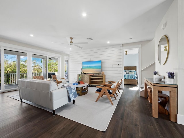 living room featuring dark hardwood / wood-style floors and ceiling fan