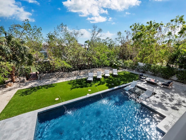 view of swimming pool with a yard and a patio