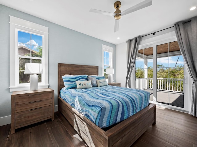 bedroom featuring dark hardwood / wood-style floors, ceiling fan, access to outside, and multiple windows