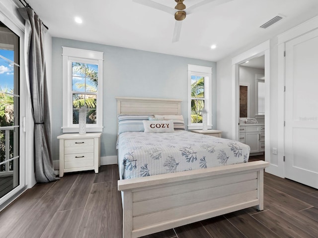 bedroom featuring ceiling fan, dark wood-type flooring, and multiple windows