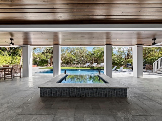 view of pool with ceiling fan and a patio area