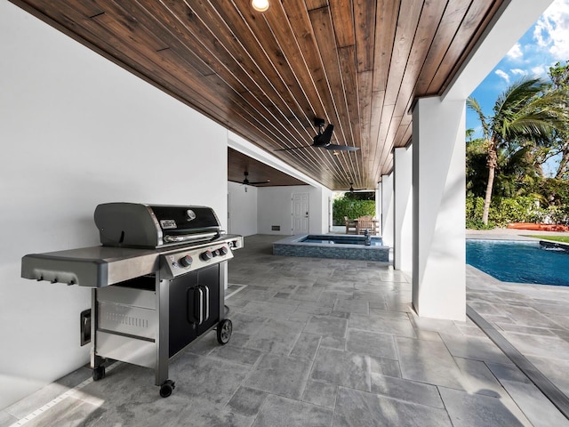 view of patio with area for grilling, ceiling fan, and a swimming pool with hot tub