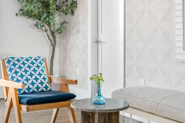 sitting room with wood-type flooring