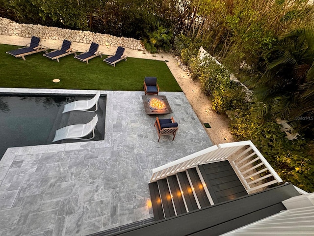 exterior space featuring a yard and an outdoor fire pit