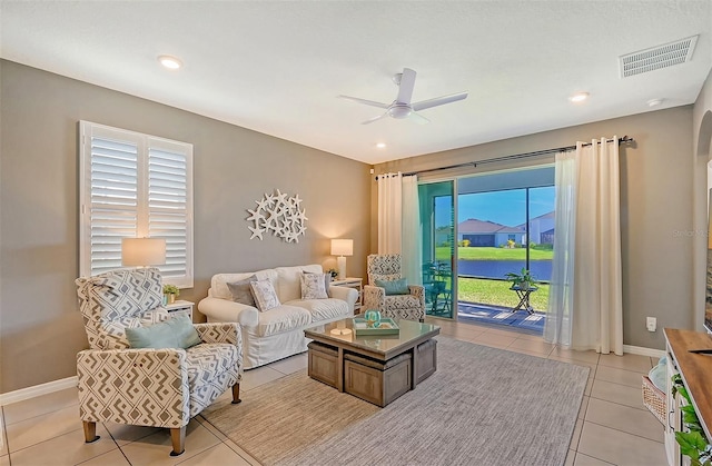 tiled living room featuring ceiling fan