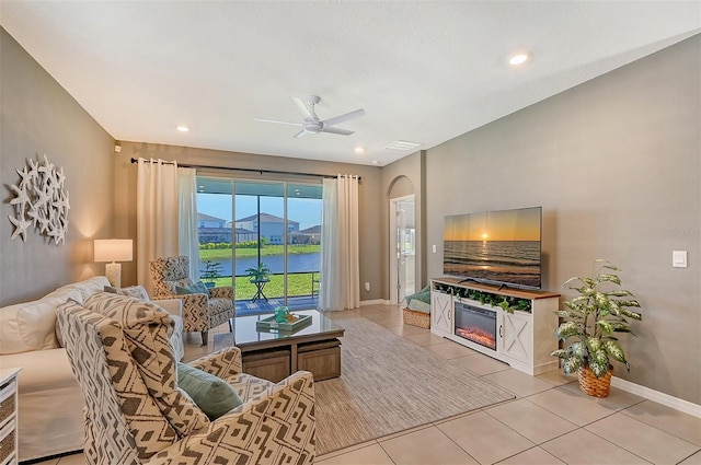 tiled living room featuring ceiling fan