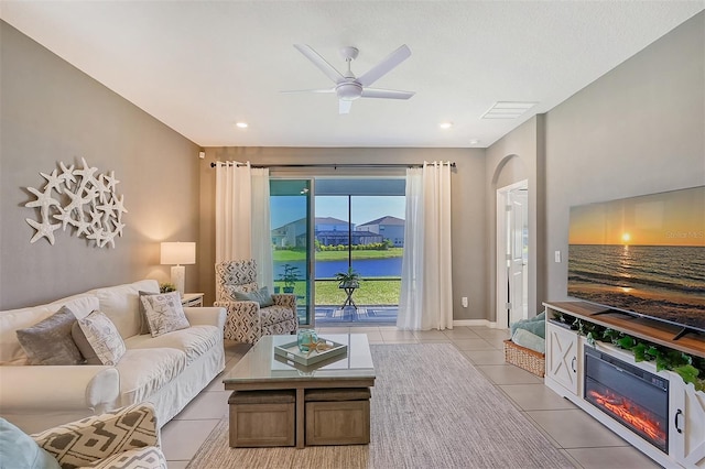 tiled living room featuring ceiling fan