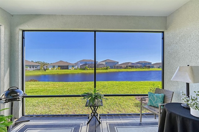 unfurnished sunroom featuring a water view and a healthy amount of sunlight