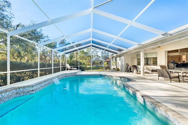 view of pool featuring a patio, ceiling fan, and a lanai