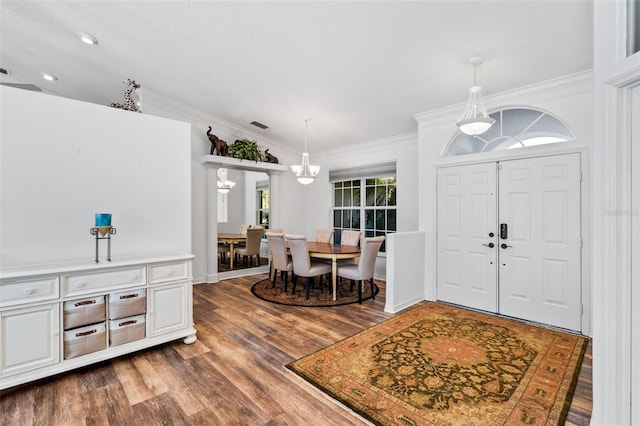 foyer entrance featuring dark hardwood / wood-style floors and ornamental molding