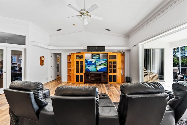 living room with crown molding, ceiling fan, wood-type flooring, and lofted ceiling