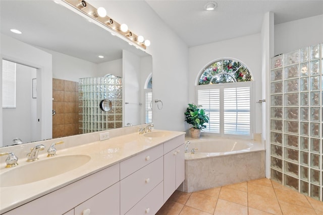 bathroom with tile patterned flooring, vanity, and shower with separate bathtub