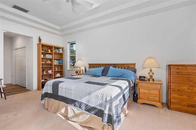 bedroom featuring ceiling fan, a closet, and light colored carpet