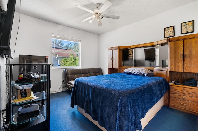 carpeted bedroom featuring a textured ceiling and ceiling fan