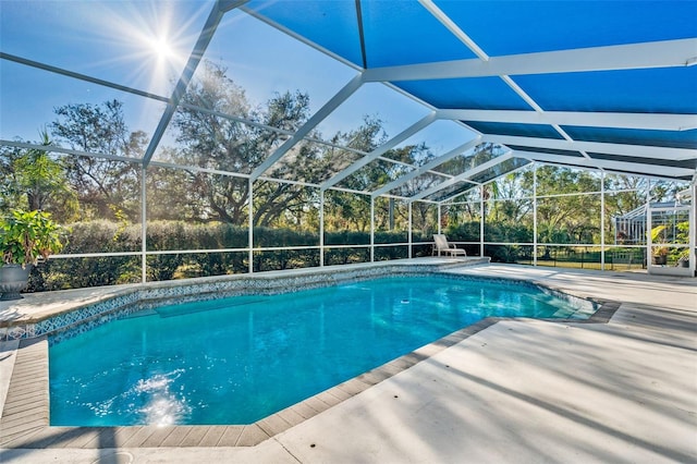 view of pool featuring a patio area and glass enclosure