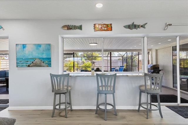 kitchen featuring a healthy amount of sunlight and a breakfast bar area