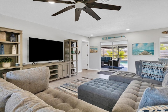 living room featuring ceiling fan and light hardwood / wood-style floors