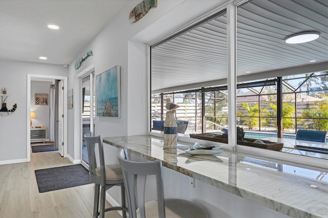 dining space featuring a healthy amount of sunlight and light hardwood / wood-style flooring