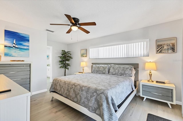 bedroom with ceiling fan and light hardwood / wood-style flooring