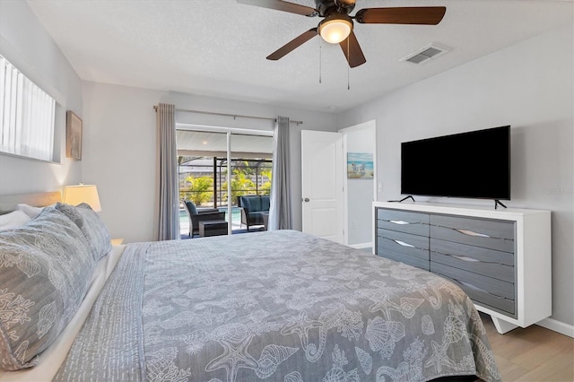 bedroom with access to outside, ceiling fan, a textured ceiling, and hardwood / wood-style flooring