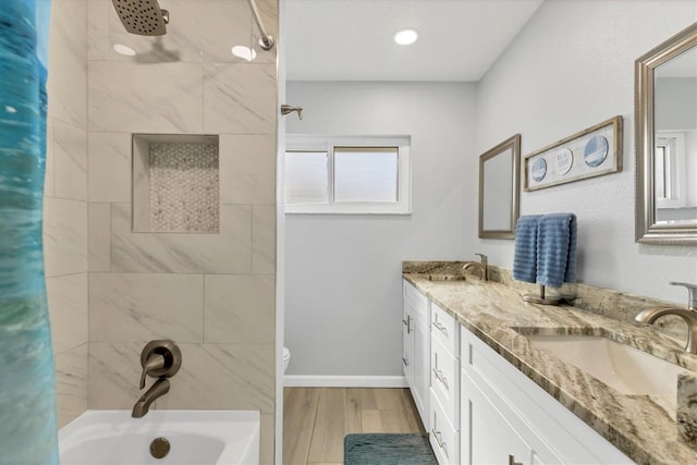 full bathroom featuring vanity, toilet, tiled shower / bath, and hardwood / wood-style flooring