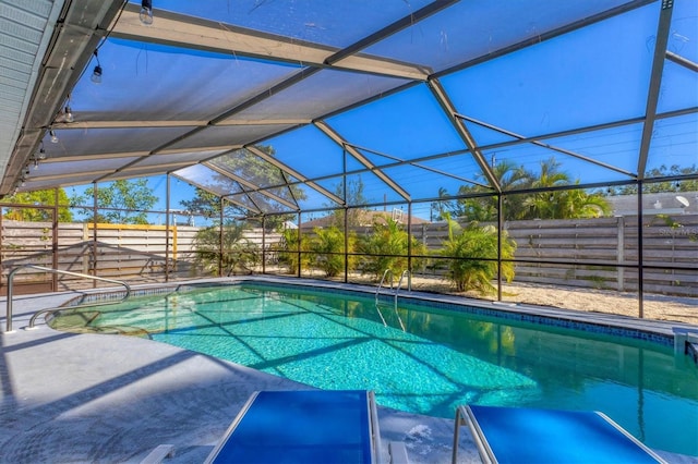 view of swimming pool featuring a lanai