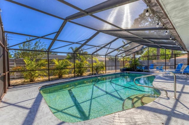 view of swimming pool with a patio area and glass enclosure