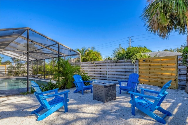 view of patio / terrace with glass enclosure and a fire pit