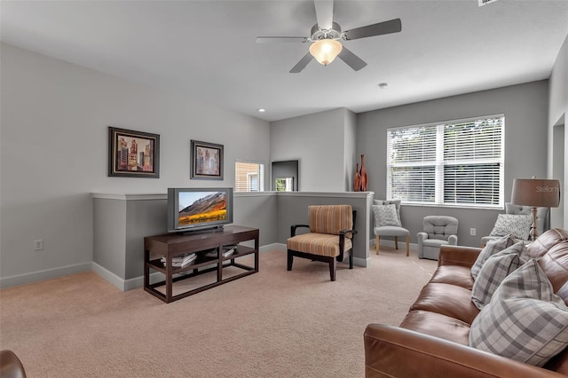 carpeted living room featuring ceiling fan and plenty of natural light