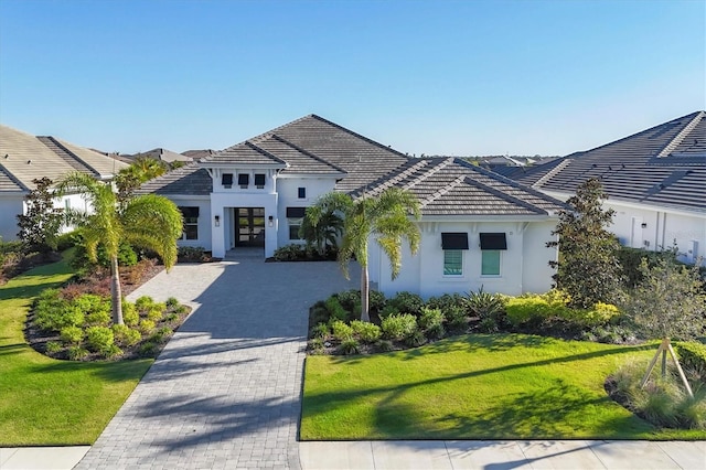 view of front facade featuring a front lawn and french doors