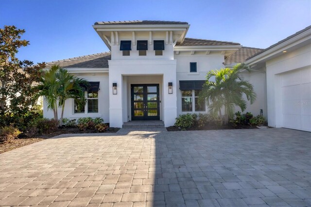 view of front of property with french doors and a garage