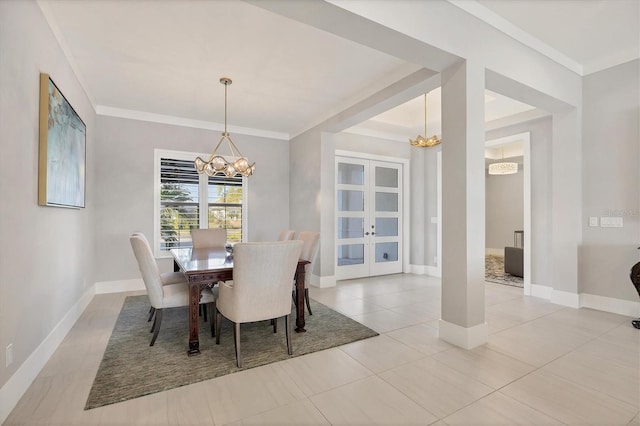 tiled dining space featuring a chandelier, french doors, and crown molding