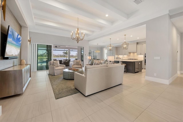 living room featuring a notable chandelier, beam ceiling, and light tile patterned floors