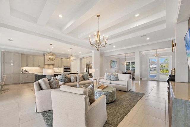 tiled living room with a chandelier, beam ceiling, sink, and french doors