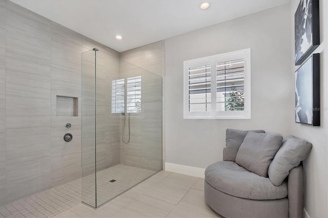 bathroom featuring tile patterned floors and a tile shower