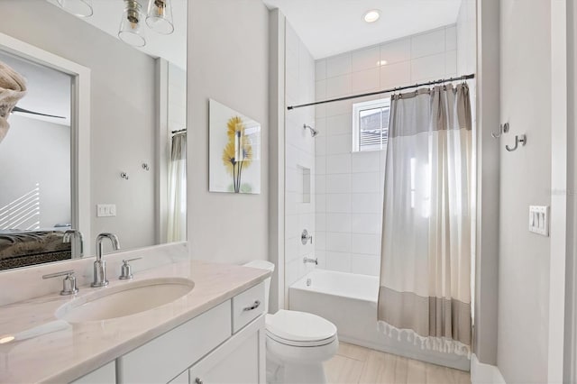 full bathroom featuring vanity, toilet, and shower / bathtub combination with curtain