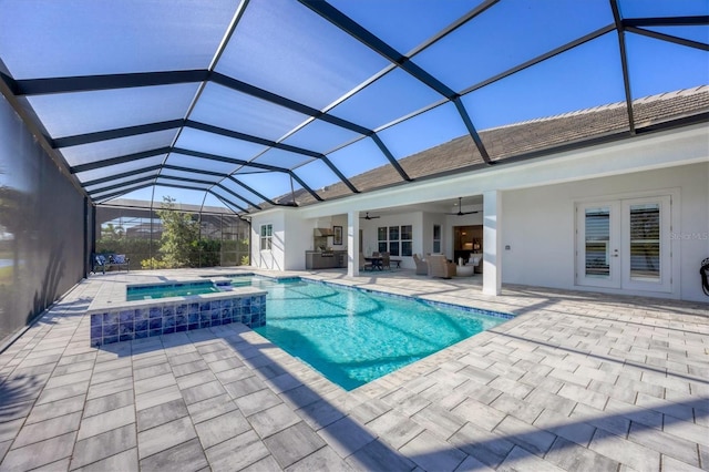 view of pool with ceiling fan, a lanai, an in ground hot tub, and french doors