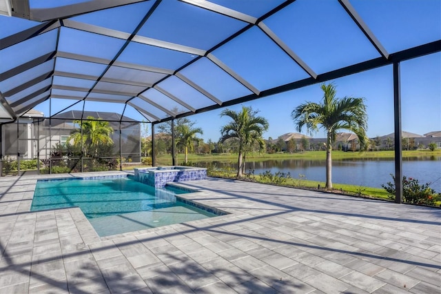 view of pool featuring glass enclosure, an in ground hot tub, a water view, and a patio