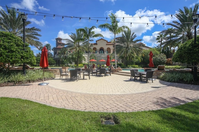 view of patio / terrace with a balcony and a swimming pool