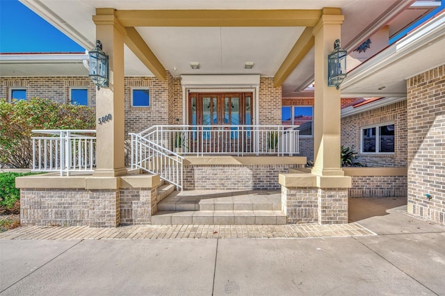 property entrance with a porch and french doors