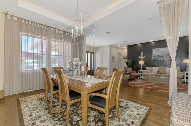 dining area with a notable chandelier and wood-type flooring