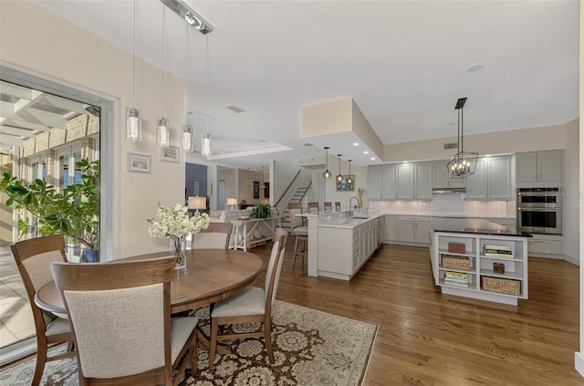 dining space featuring hardwood / wood-style floors and sink