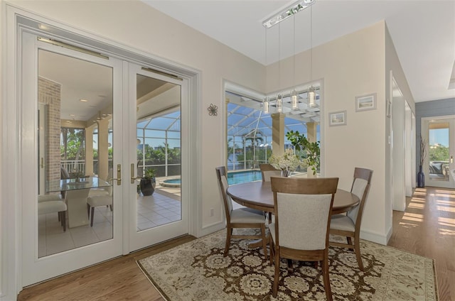 dining space featuring light hardwood / wood-style flooring and french doors