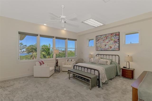 bedroom with ceiling fan and light carpet