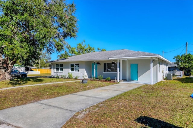 ranch-style home featuring cooling unit and a front yard