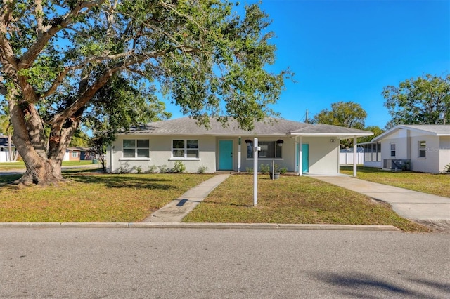 ranch-style home featuring a front yard and a carport